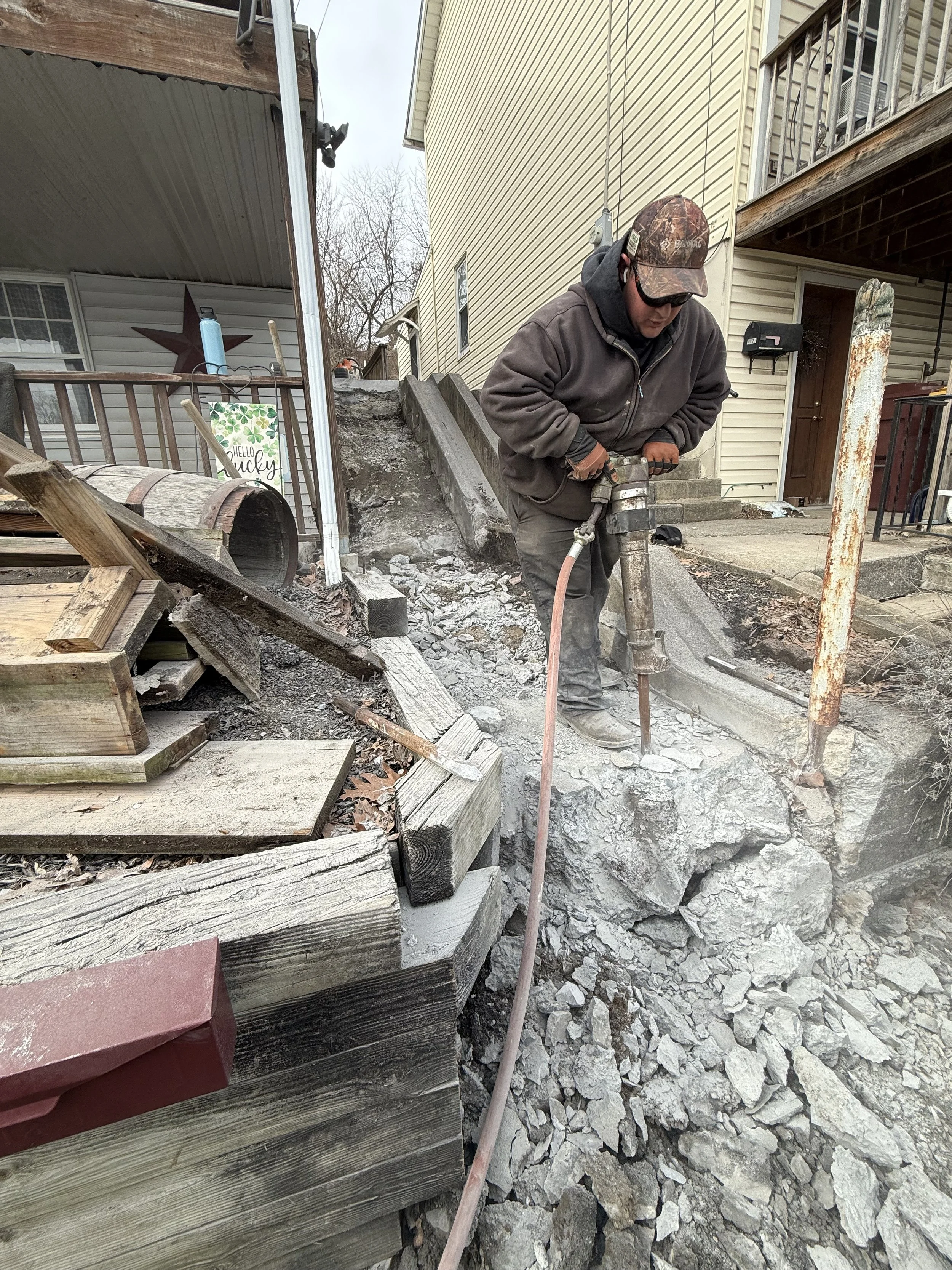 Concrete entry steps and landing under construction during a Murray General Contracting rebuild