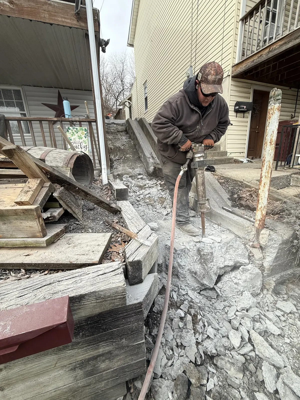 Concrete entry steps and landing under construction during a Murray General Contracting rebuild
