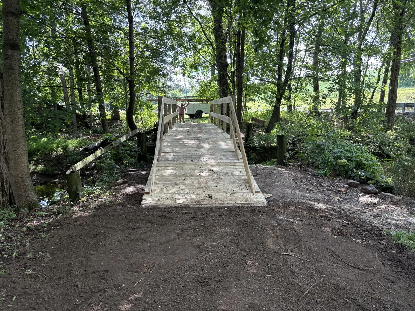 Wooden footbridge built over a creek by Murray General Contracting