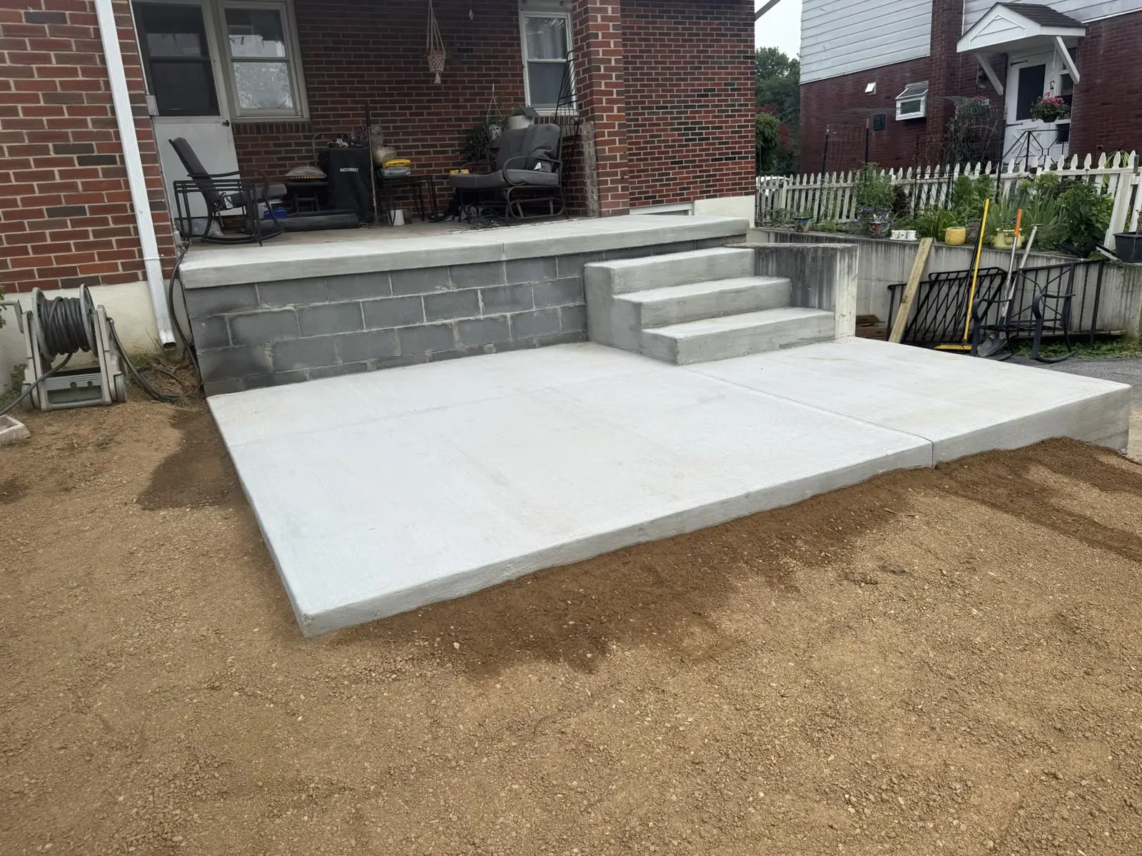 A concrete patio and steps freshly formed and poured