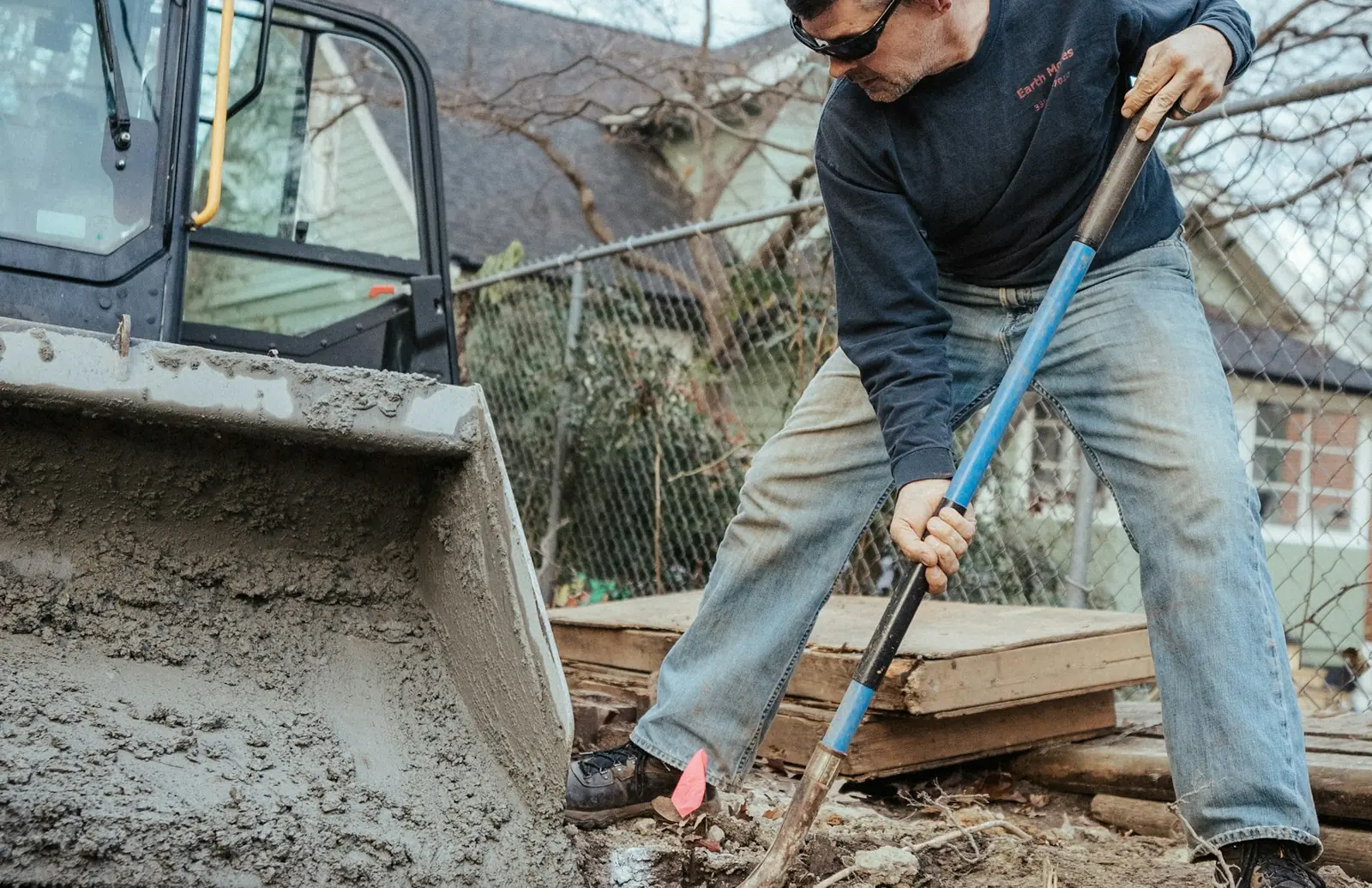 Yard regraded with a shallow swale shaped to carry runoff to a lower outlet
