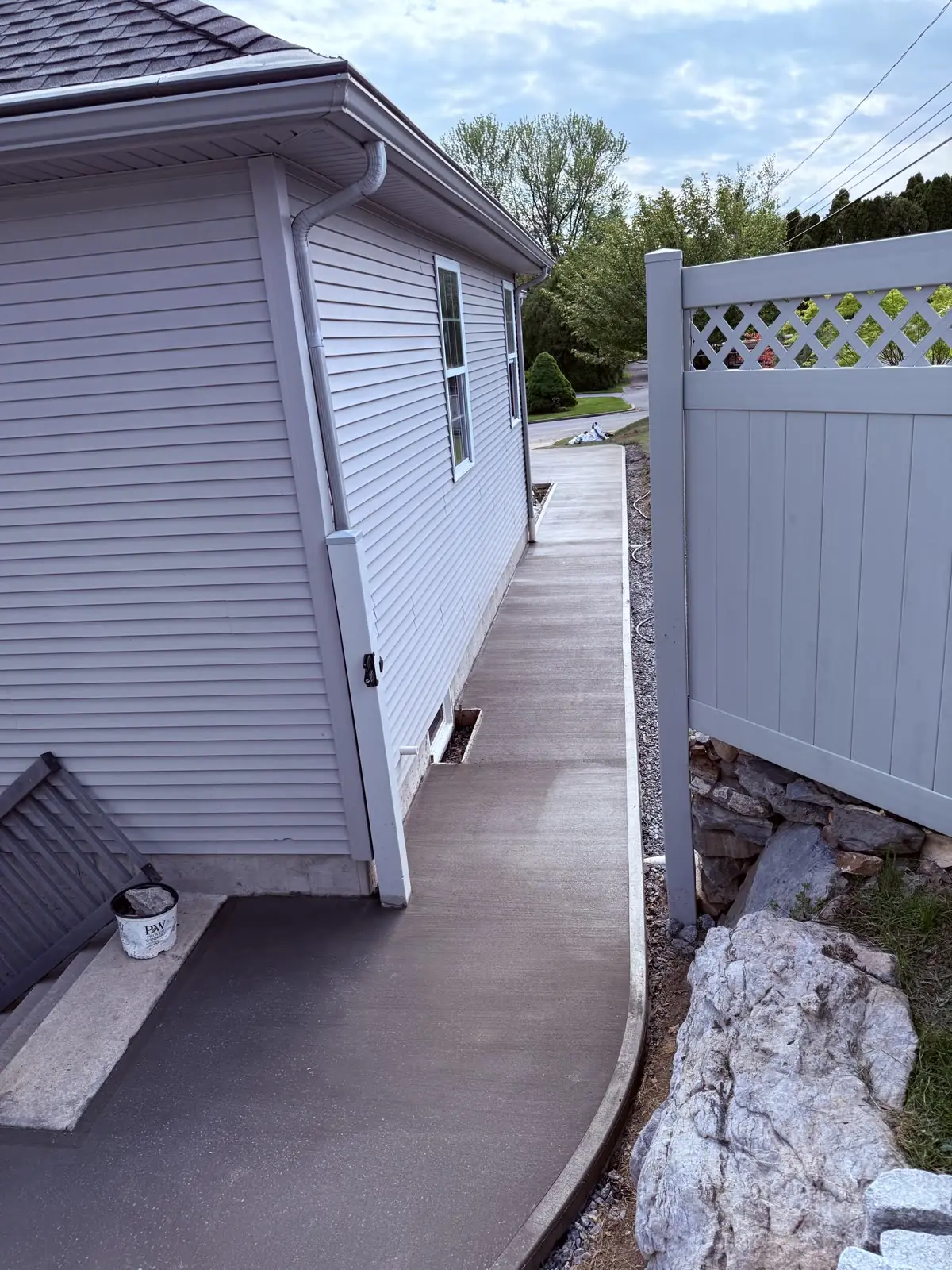 Concrete walkway poured tight along the side of a house